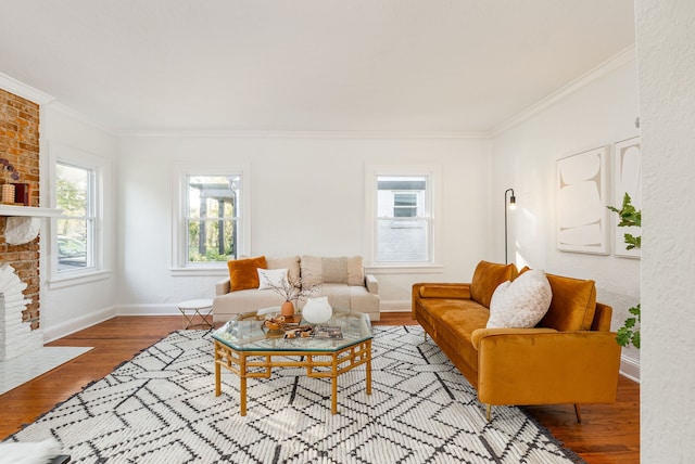 living room featuring light hardwood / wood-style flooring, a fireplace, and crown molding