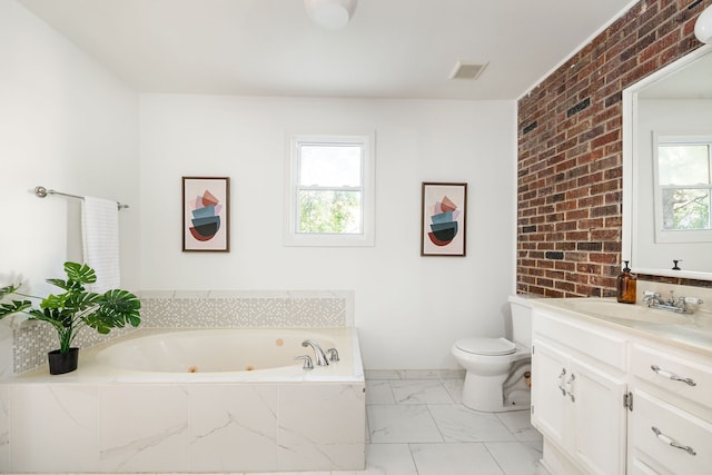 bathroom with vanity, toilet, a bath, and brick wall