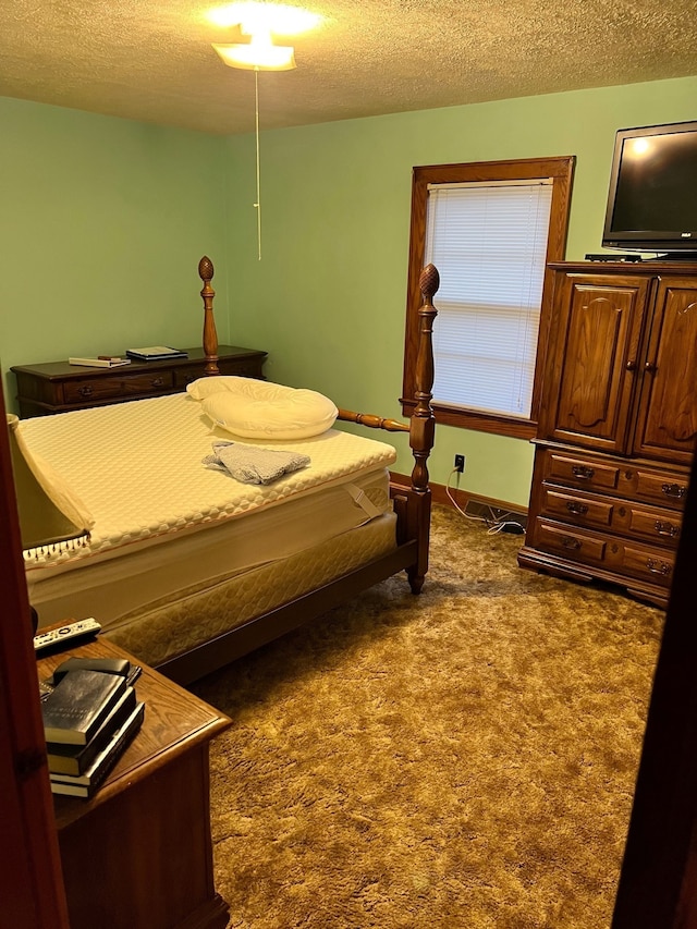 carpeted bedroom featuring a textured ceiling