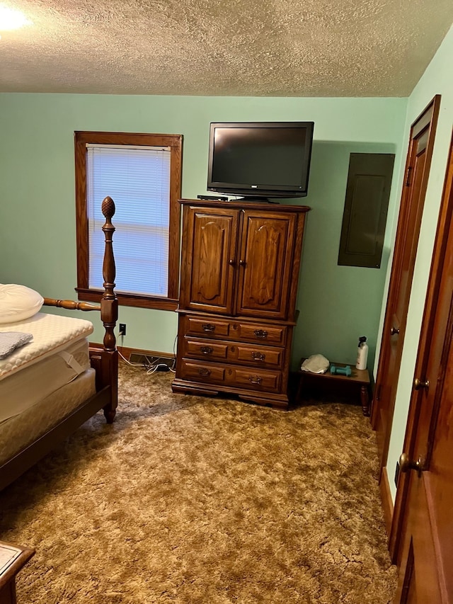 bedroom with carpet flooring and a textured ceiling