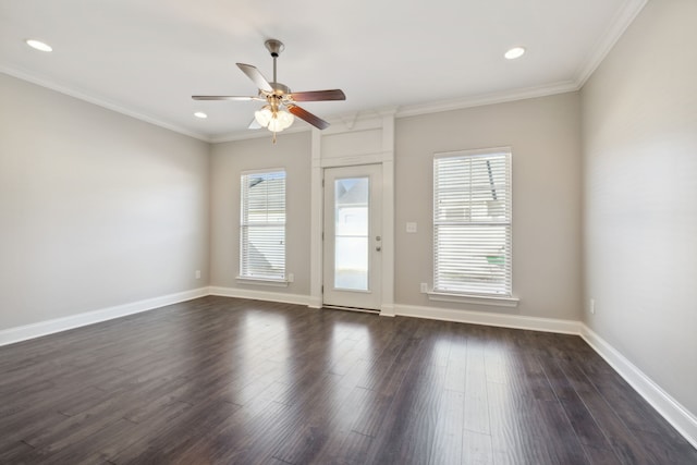 empty room featuring crown molding, dark wood-type flooring, and ceiling fan