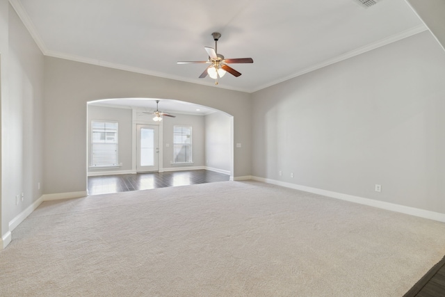 empty room featuring carpet, ornamental molding, and ceiling fan