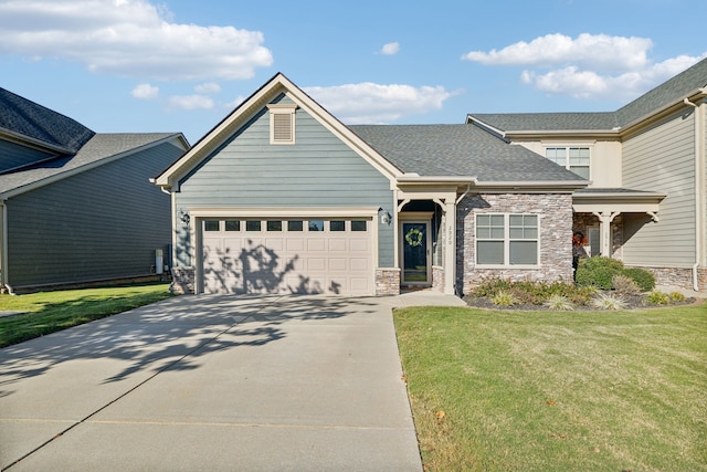 craftsman inspired home featuring a front yard and a garage