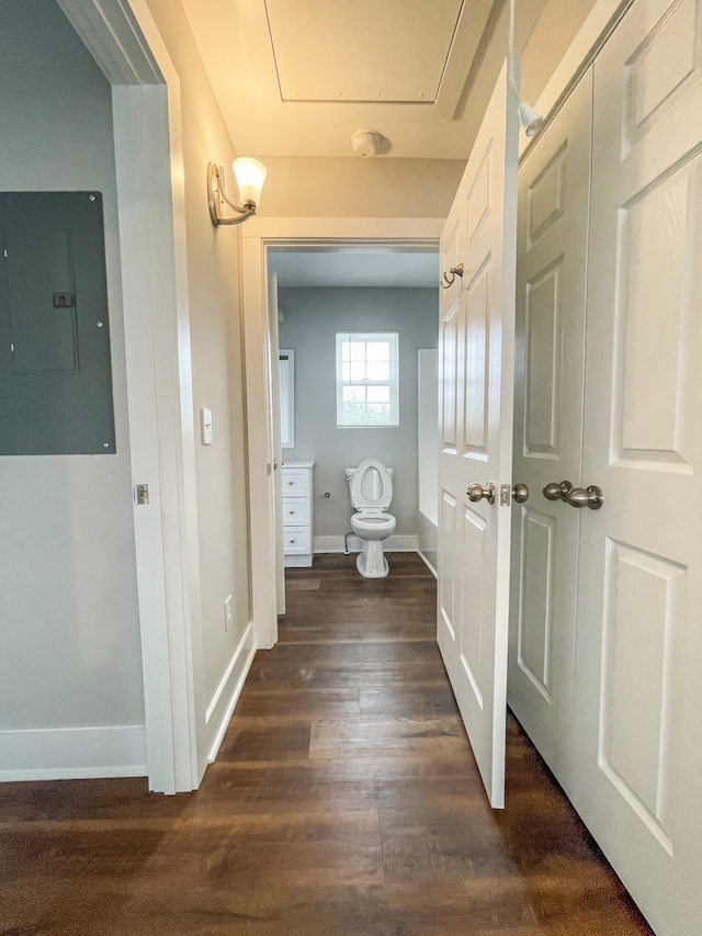 bathroom featuring toilet, hardwood / wood-style floors, and electric panel