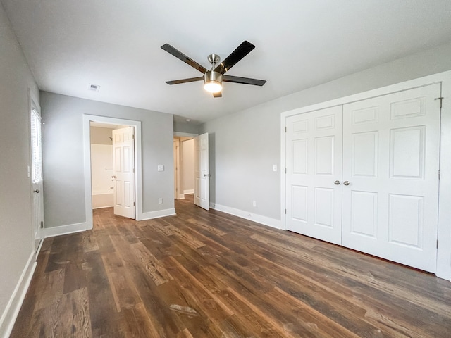 unfurnished bedroom featuring dark hardwood / wood-style floors, a closet, and ceiling fan