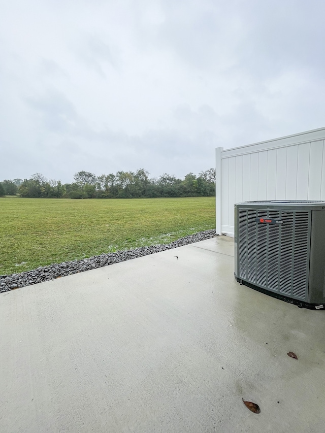 view of patio / terrace featuring central air condition unit and a rural view