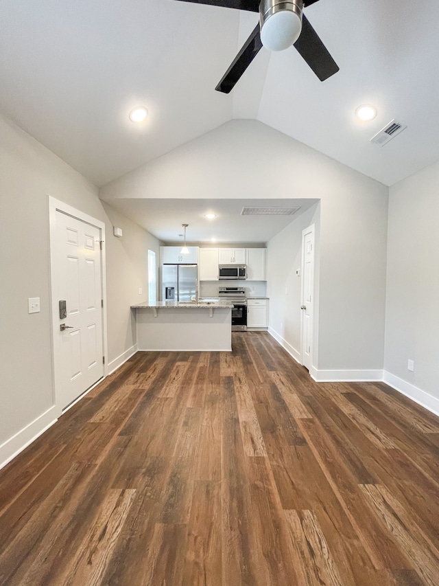 unfurnished living room featuring ceiling fan, lofted ceiling, and dark hardwood / wood-style floors