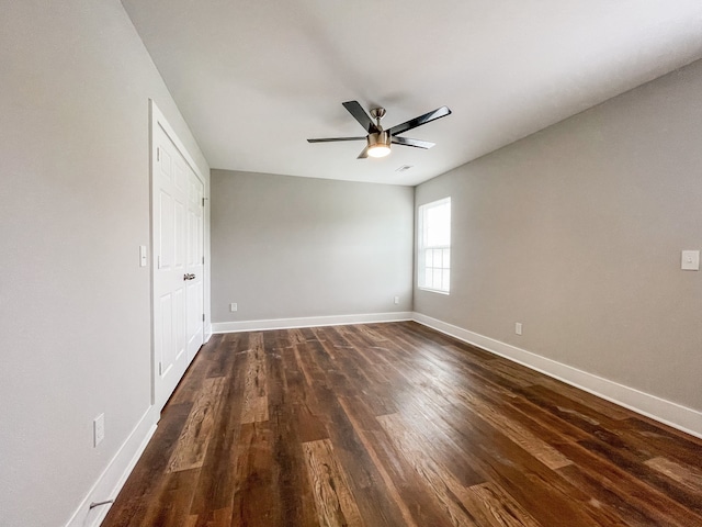 unfurnished bedroom with ceiling fan and dark hardwood / wood-style floors