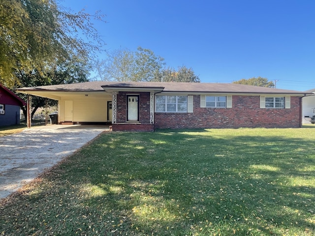 ranch-style house featuring a carport and a front lawn