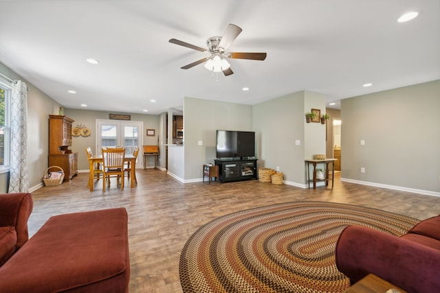 living room featuring ceiling fan and wood-type flooring