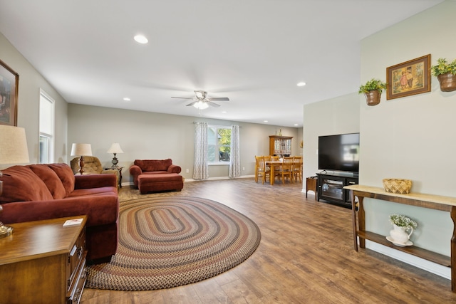 living room with hardwood / wood-style floors and ceiling fan