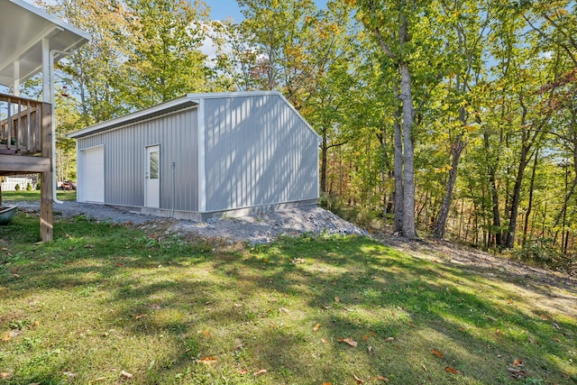 view of outbuilding with a yard and a garage