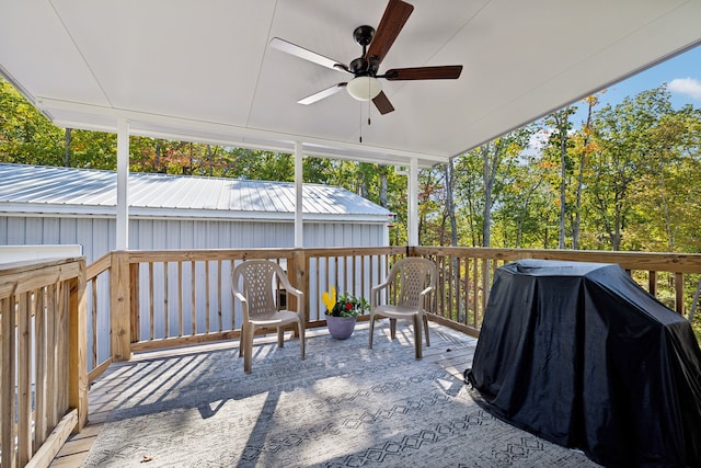 deck featuring area for grilling and ceiling fan