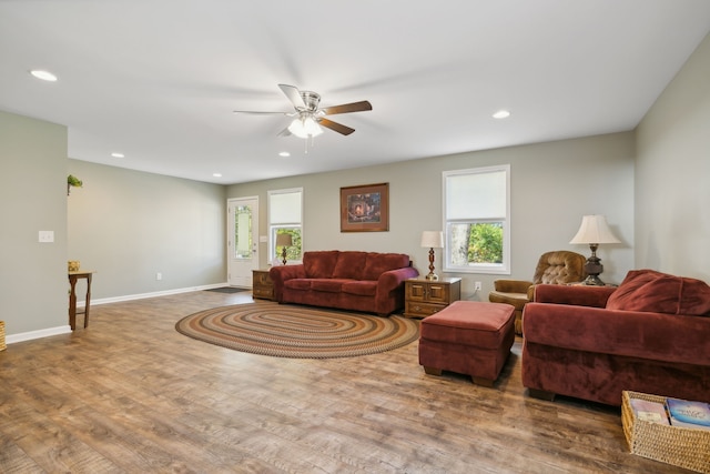 living room featuring ceiling fan and hardwood / wood-style flooring