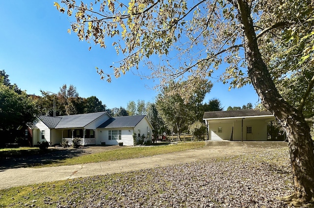 view of front of house featuring an attached carport and driveway