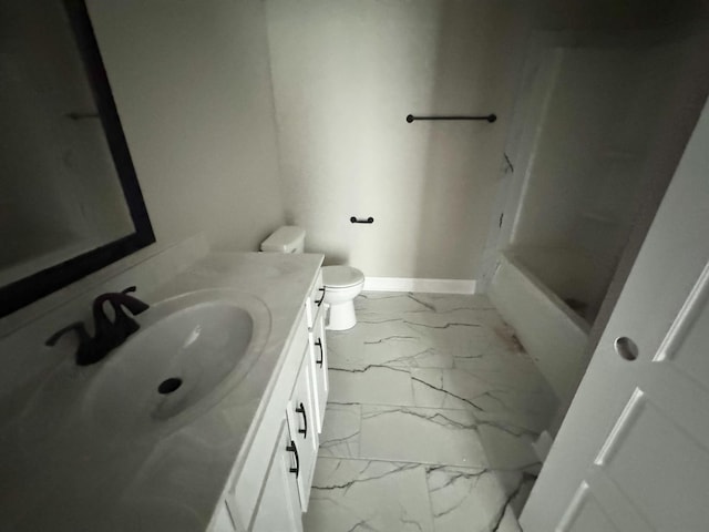 bathroom featuring marble finish floor, toilet, vanity, and baseboards