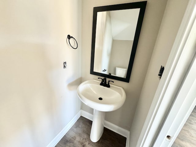 bathroom with hardwood / wood-style floors