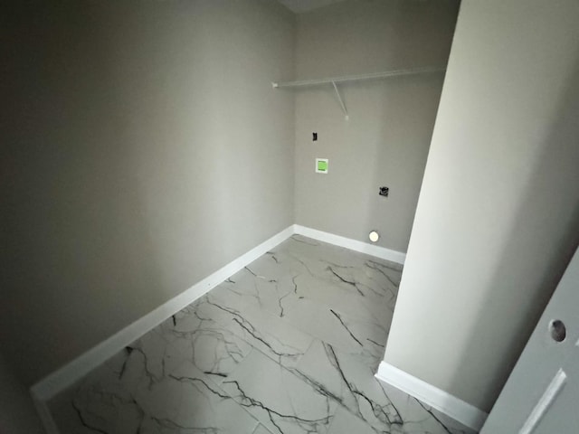 laundry room with marble finish floor and baseboards