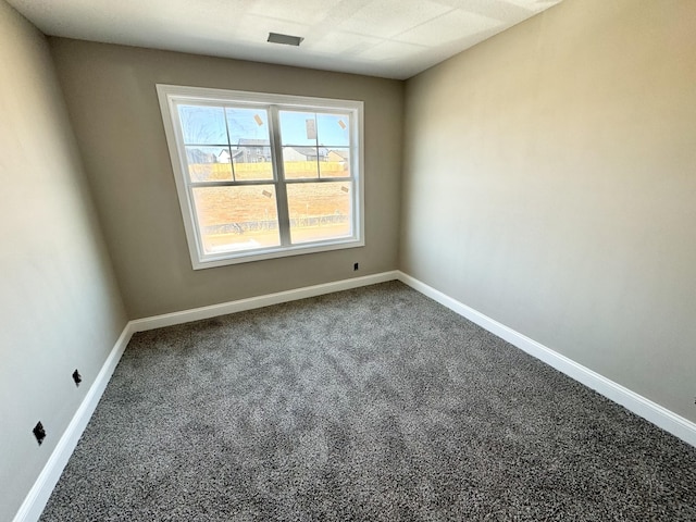 spare room with visible vents, baseboards, and carpet floors