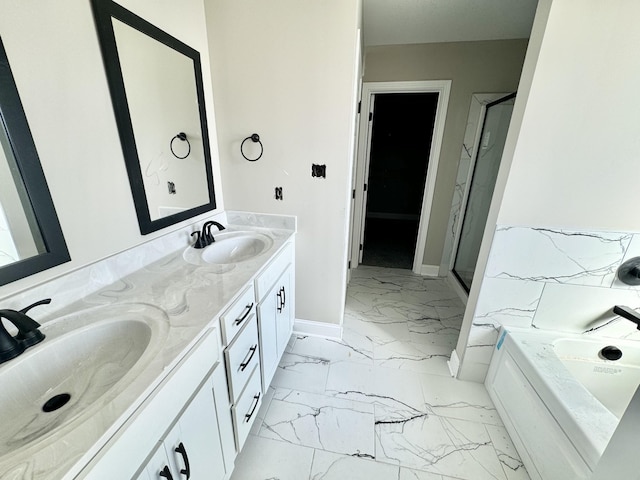 bathroom featuring a sink, marble finish floor, a stall shower, and double vanity