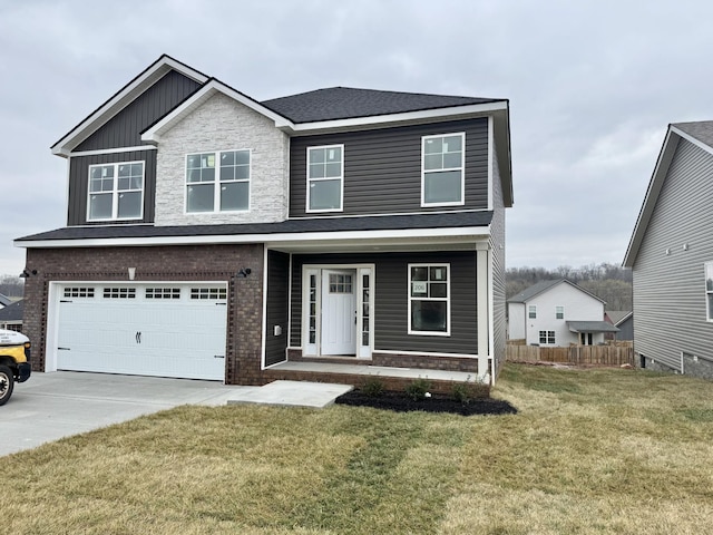 view of front of property with a front yard, fence, driveway, an attached garage, and board and batten siding