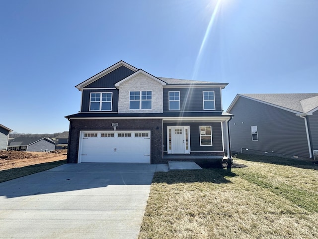 view of front of house featuring concrete driveway, a garage, and a front lawn