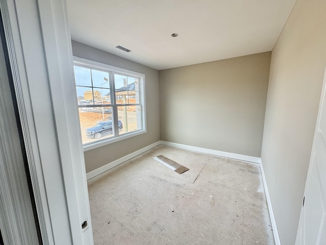 spare room with visible vents and baseboards