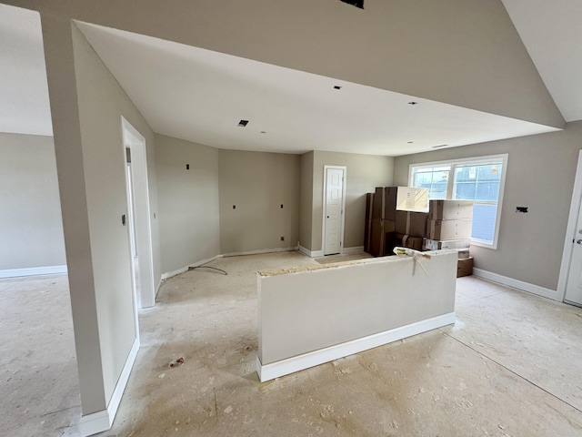 unfurnished living room featuring baseboards