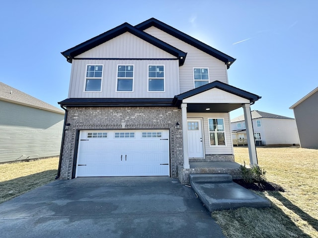 view of front facade featuring driveway, an attached garage, board and batten siding, and brick siding