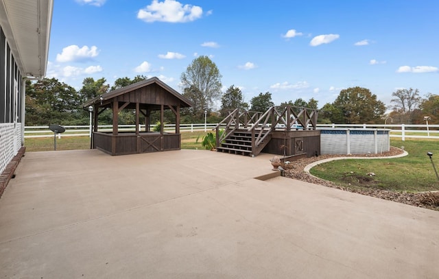 view of patio with a gazebo and a fenced in pool