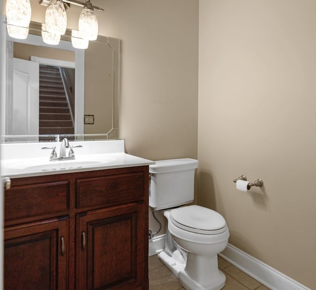 bathroom featuring vanity, toilet, and tile patterned flooring