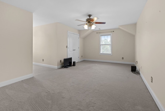 additional living space with light carpet, lofted ceiling, and ceiling fan