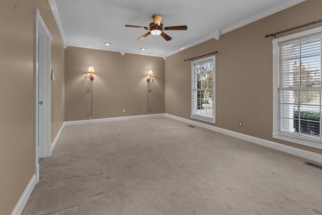 unfurnished room featuring crown molding, ceiling fan, light carpet, and plenty of natural light