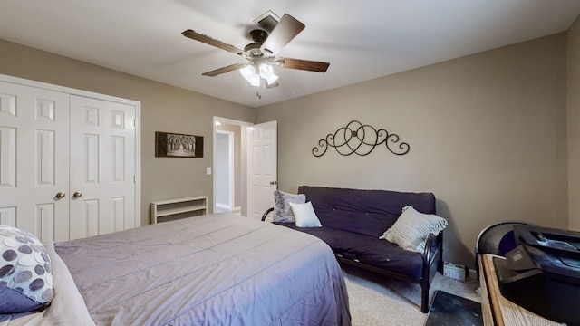 carpeted bedroom with a closet and ceiling fan