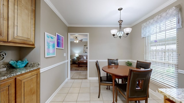 tiled dining area featuring crown molding and ceiling fan with notable chandelier