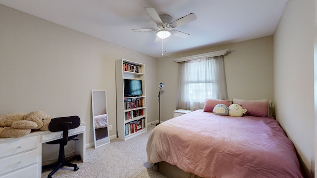 bedroom featuring ceiling fan and light carpet