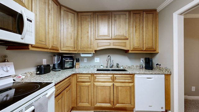 kitchen featuring ornamental molding, light stone countertops, sink, and white appliances