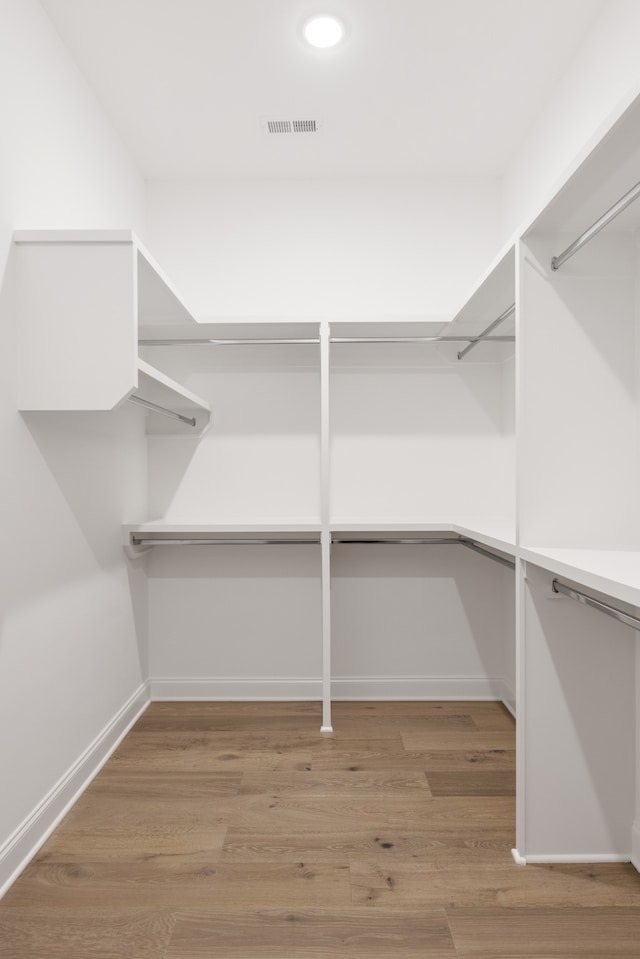 spacious closet featuring light hardwood / wood-style floors