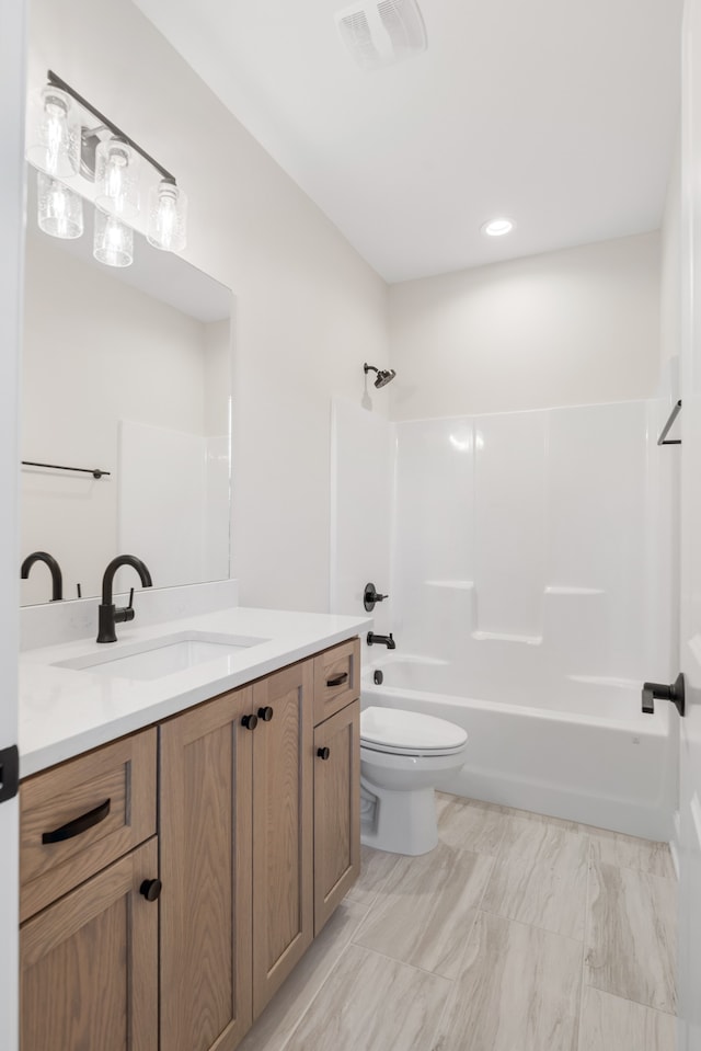 full bathroom featuring toilet, bathtub / shower combination, and vanity