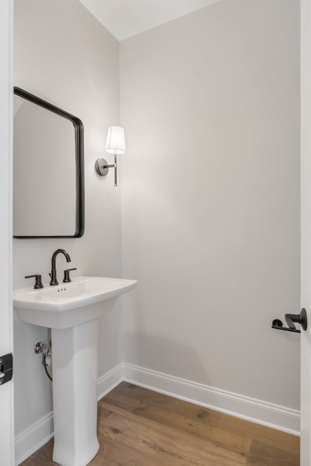 bathroom with hardwood / wood-style flooring and sink