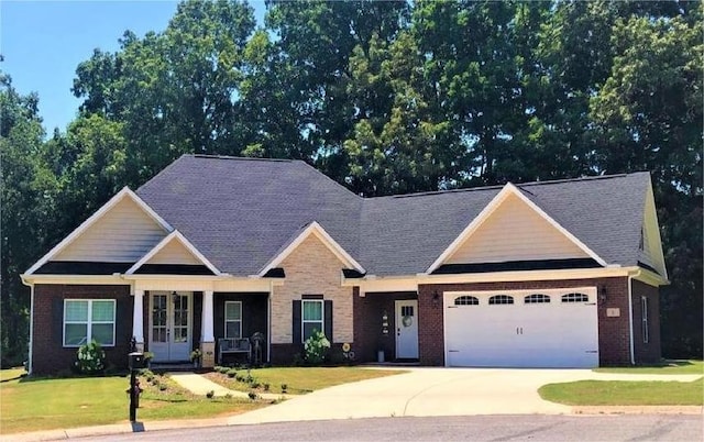 craftsman-style home featuring a porch, a garage, and a front lawn