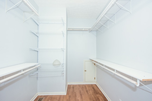 spacious closet with hardwood / wood-style floors