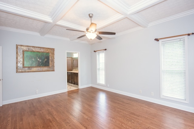 empty room with ornamental molding, coffered ceiling, and wood-type flooring