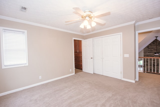 unfurnished bedroom with a closet, ceiling fan, ornamental molding, and light colored carpet