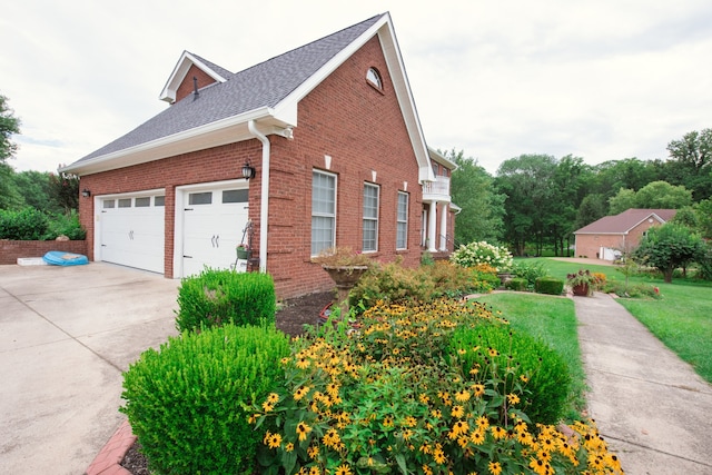 view of home's exterior with a yard and a garage