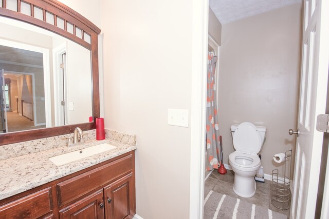 bathroom featuring tile patterned floors, toilet, vanity, a textured ceiling, and walk in shower