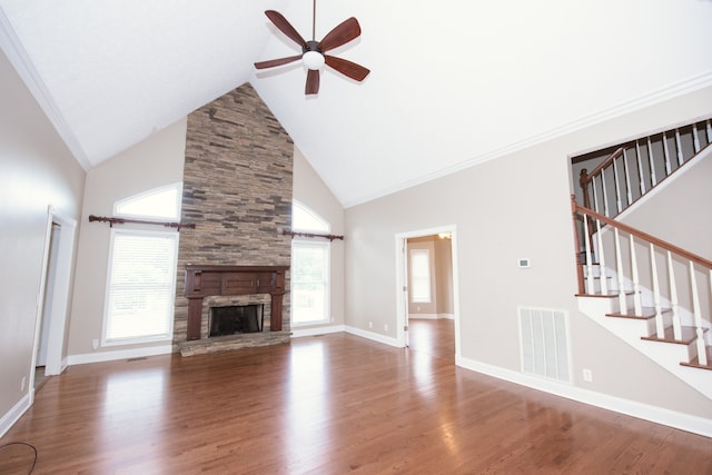 unfurnished living room featuring high vaulted ceiling, a fireplace, and hardwood / wood-style floors