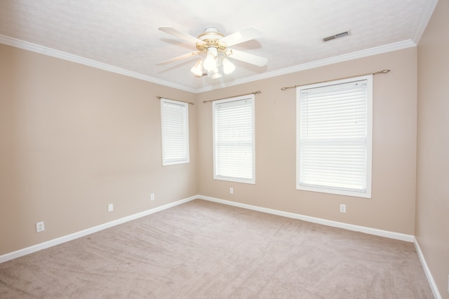 unfurnished room with ornamental molding, light colored carpet, and ceiling fan