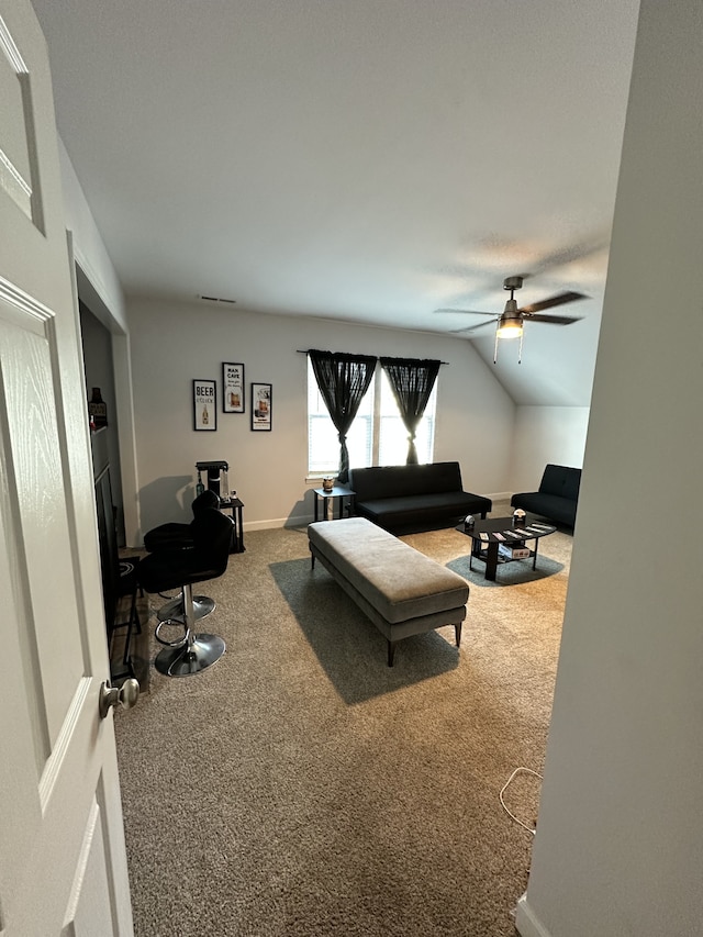 living room featuring lofted ceiling, carpet floors, and ceiling fan