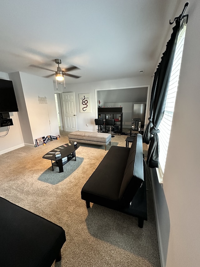 carpeted living room with ceiling fan